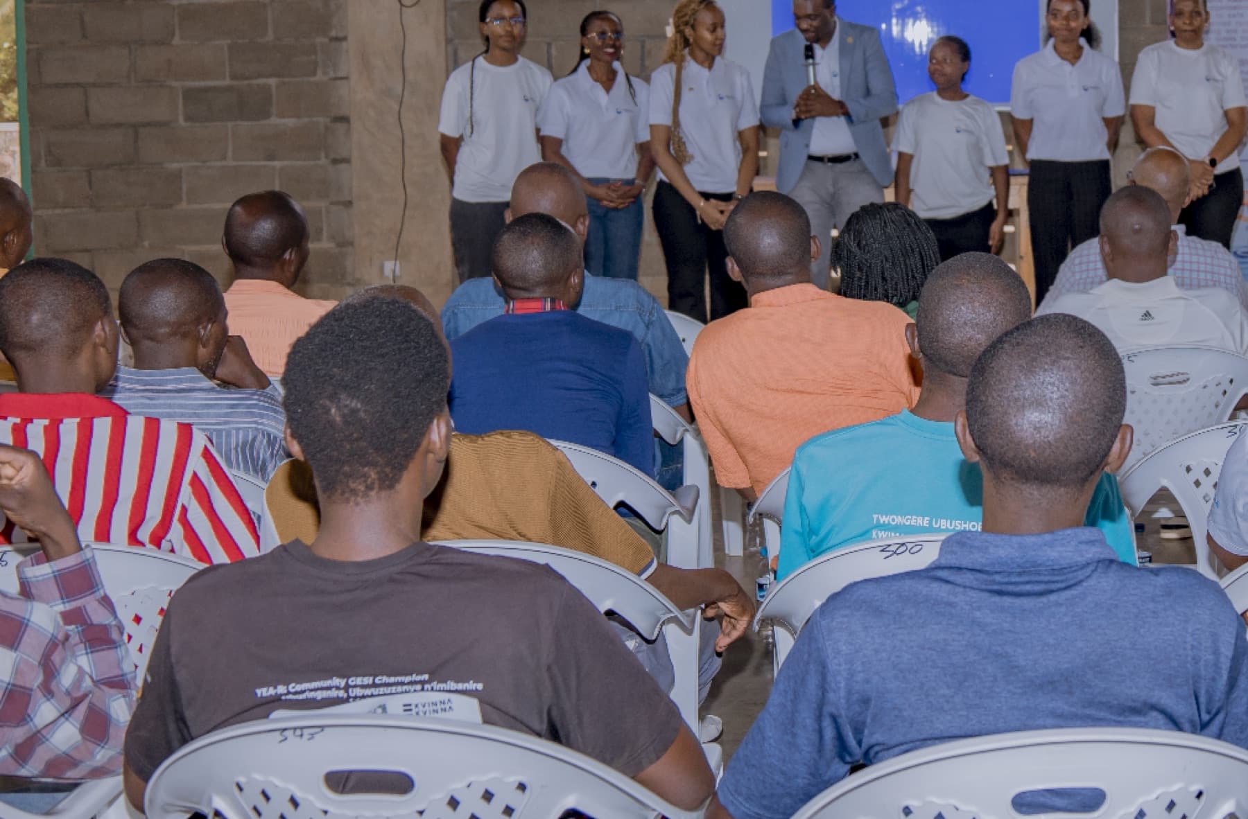 A SAquaSolve WASH and community workshop in Gashora, with the team addressing a full room.